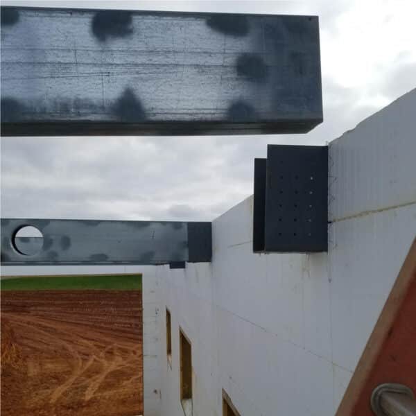 Image of a beam being placed into a ICF Beam Hanger for Suspended Concrete Floor Systems by Metwood Building Solutions.